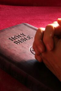 Holy Bible and Praying Hand
